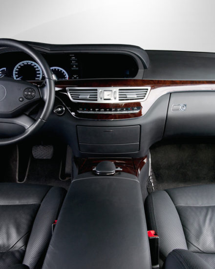 A car 's dashboard and steering wheel are shown.