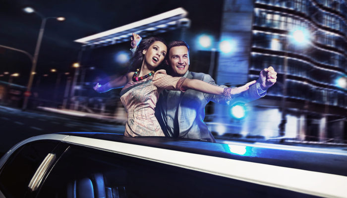 A man and woman are driving in the car.