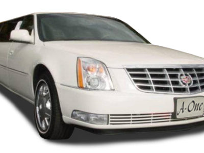 A white car is parked in front of the camera.