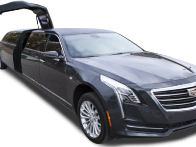 A gray cadillac car with its doors open.